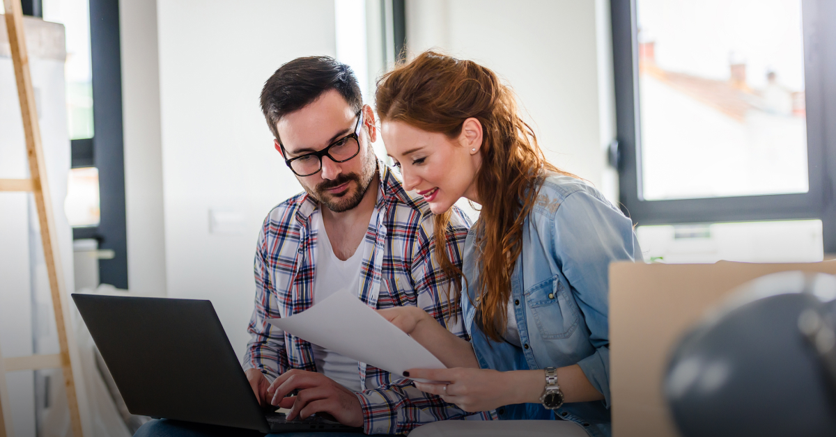 Two people look for their student bank account options on a laptop