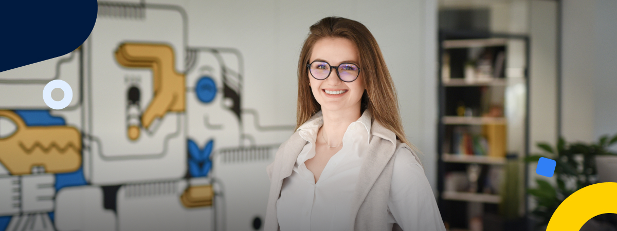 Monika Snitke wears glasses and smiles while standing in front of TransferGo